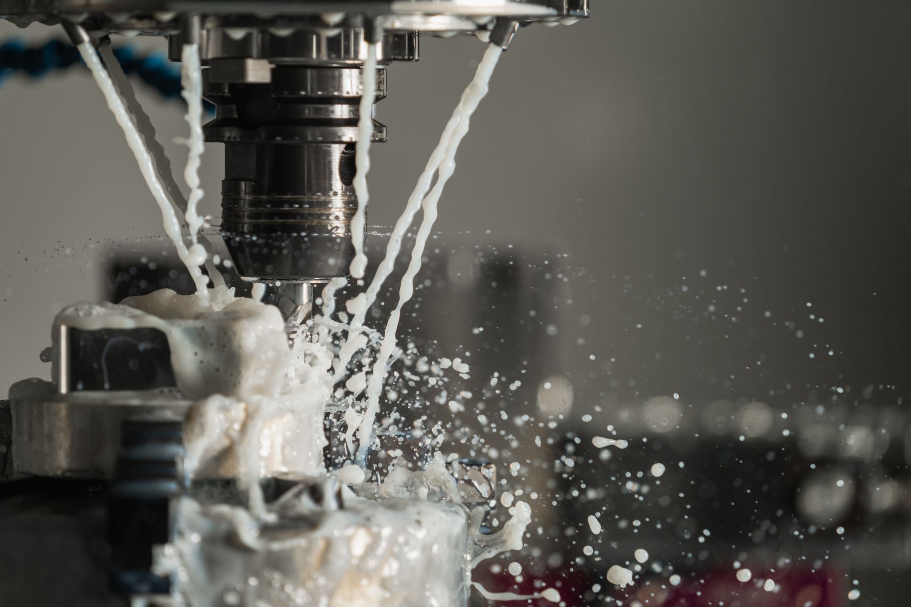 A machinist checks a part on a CNC lathe in a Chicagoland shop